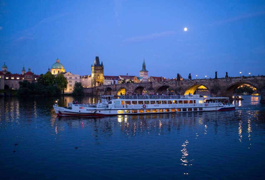 Prague: City Tour and Dinner Cruise with Hotel Pickup - Boarding the Vltava boat, dinner setup, and where the best photos happen