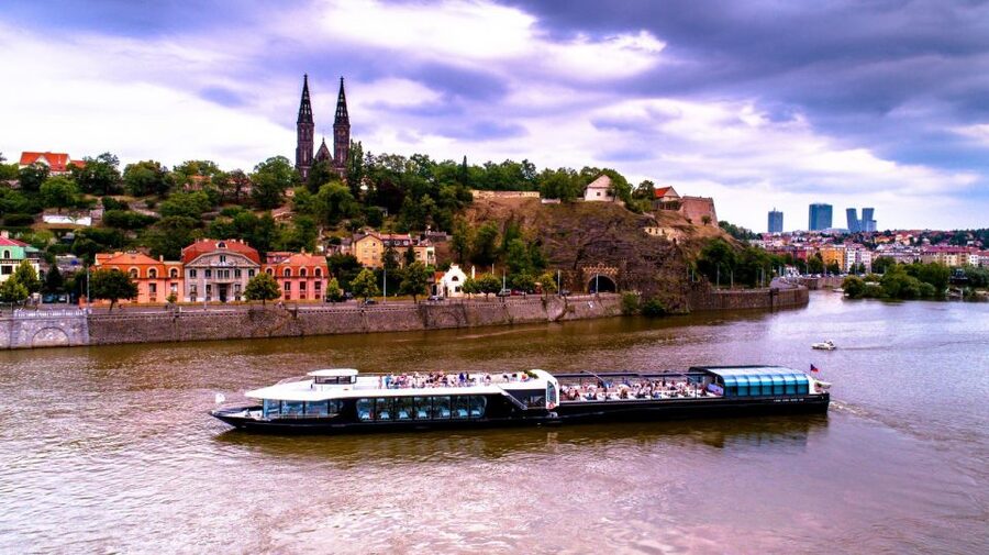 Prague: Sightseeing Dinner Cruise on Open-Top Glass Boat - Before you even leave the pier: welcome drink, quick start, and audio you can follow